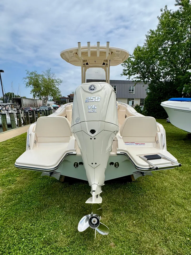 Slide: The Image of 2025 Grady-White Fisherman 216 boat with powerful outboard motor, docked on grass. - 3