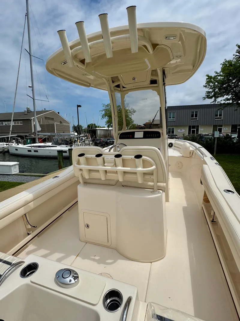 Slide: The Image of 2025 Grady-White Fisherman 216 boat with center console and rod holders, docked at marina. - 5