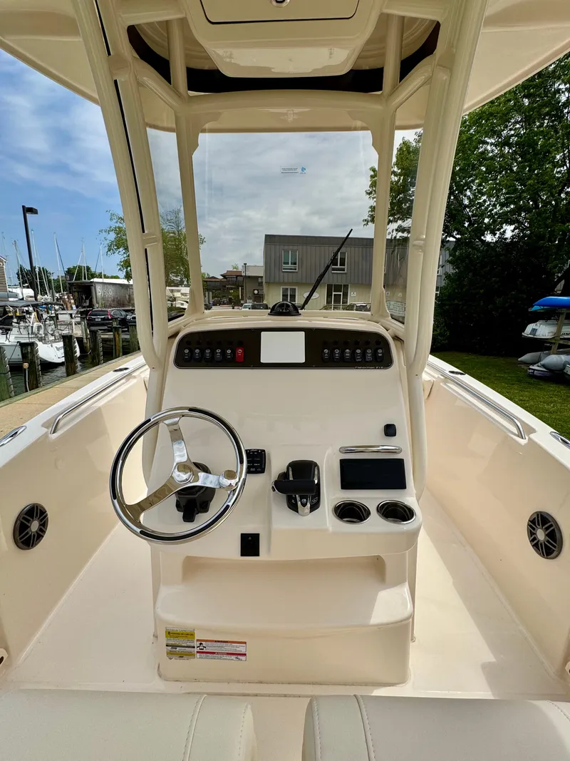 Slide: The Image of 2025 Grady-White Fisherman 216 boat console with steering wheel and controls. - 7