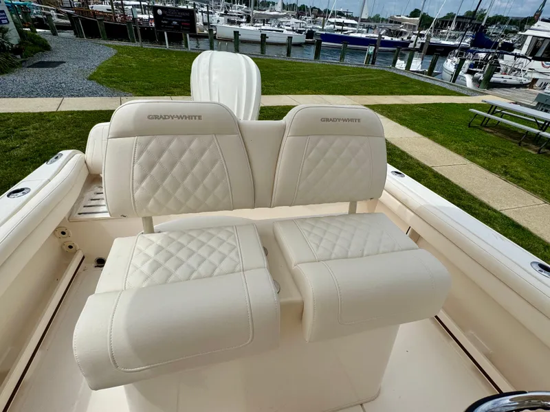 Slide: The Image of 2025 Grady-White Fisherman 216 boat seats with quilted design at marina. - 8