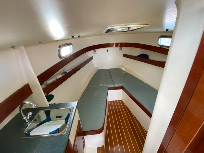 Slide: The Image of Interior of 2008 Landing School Arundel 27 boat with seating and kitchenette. - 17