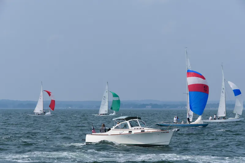 Slide: The Image of A 2008 Landing School Arundel 27 motorboat on a lake with colorful sailboats. - 2
