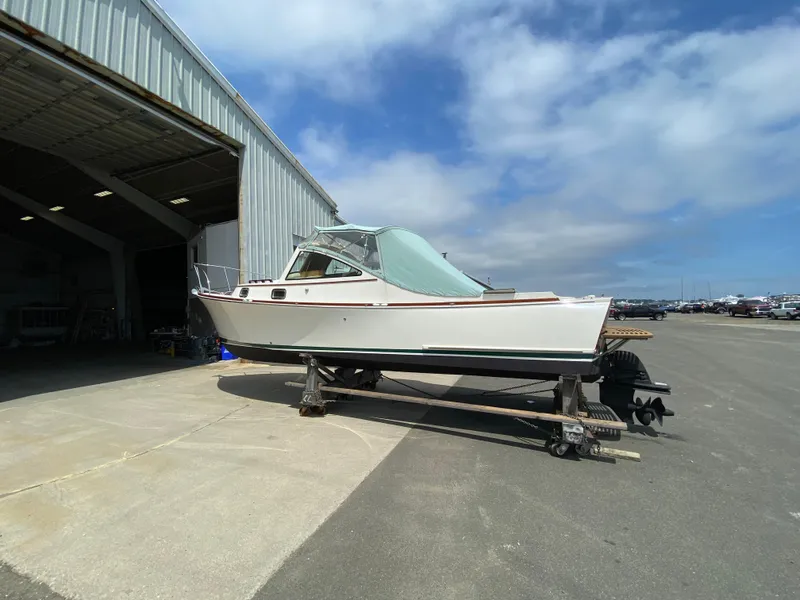 Slide: The Image of 2008 Landing School Arundel 27 boat on trailer outside a large warehouse. - 21
