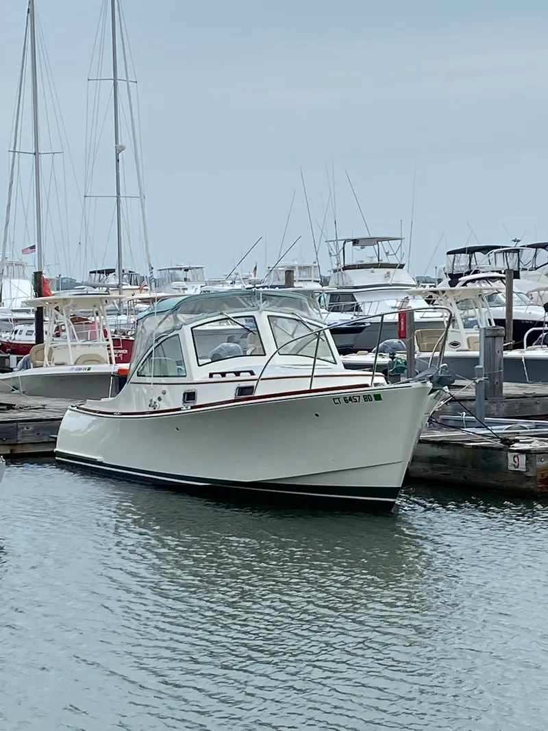 Slide: The Image of 2008 Landing School Arundel 27 boat docked in a marina. - 4