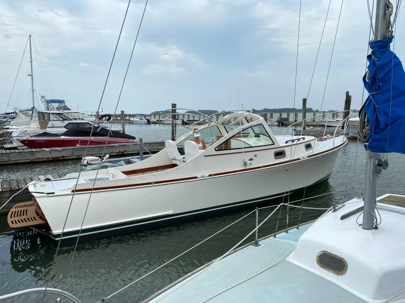 Slide: The Image of 2008 Landing School Arundel 27 boat docked at marina, clear sky, calm water. - 7