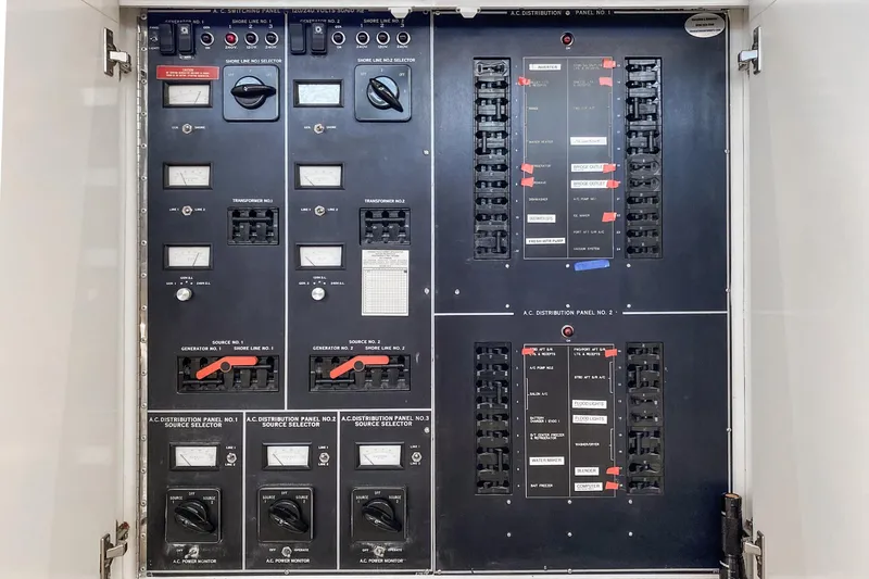 Slide: The Image of Electrical panel of a 1990 Hatteras 58 Sportfish boat, featuring switches and meters. - 11