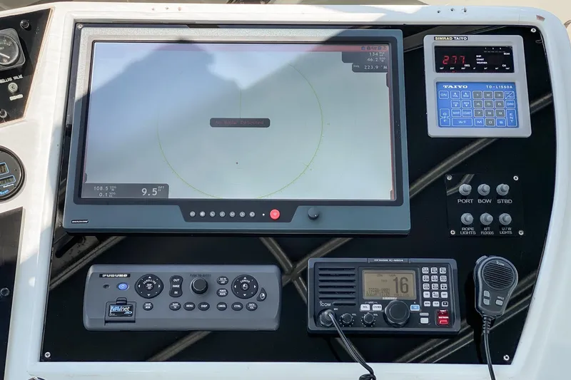 Slide: The Image of Control panel of a 1990 Hatteras 58 Sportfish with navigation and communication equipment. - 15