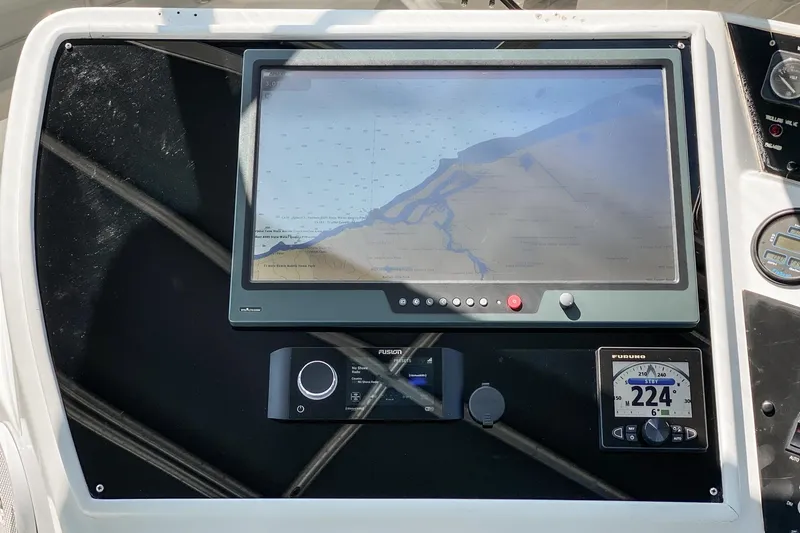 Slide: The Image of Navigation system on 1990 Hatteras 58 Sportfish boat, featuring a digital display and controls. - 16