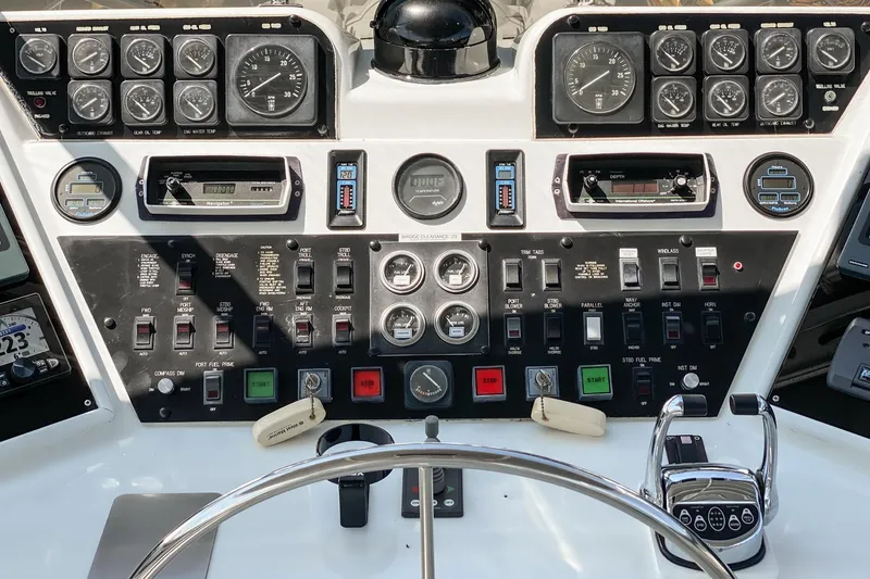 Slide: The Image of Control panel of a 1990 Hatteras 58 Sportfish boat with gauges and switches. - 17