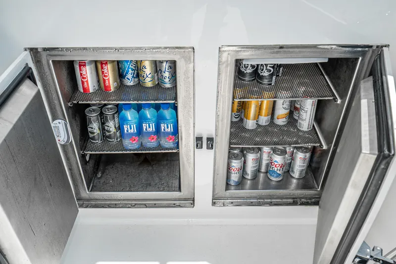 Slide: The Image of Stainless steel beverage coolers on a 1990 Hatteras 58 Sportfish, stocked with drinks. - 19
