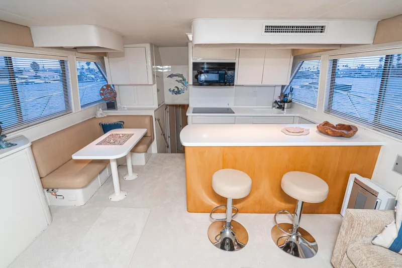 Slide: The Image of Interior of 1990 Hatteras 58 Sportfish yacht with modern kitchen and dining area. - 23