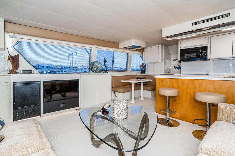Slide: The Image of Interior of 1990 Hatteras 58 Sportfish yacht with modern furnishings and panoramic windows. - 24
