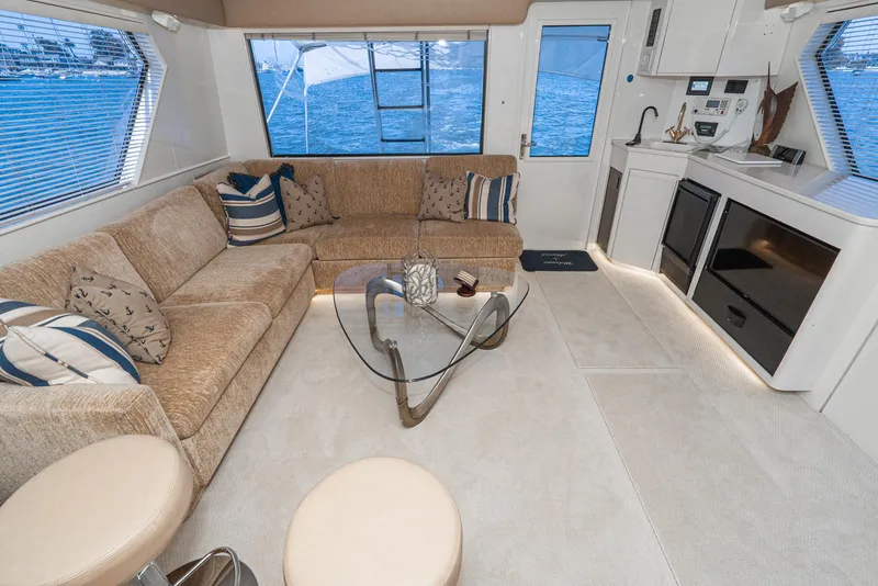 Slide: The Image of Luxurious interior of a 1990 Hatteras 58 Sportfish yacht with modern furnishings and ocean view. - 25