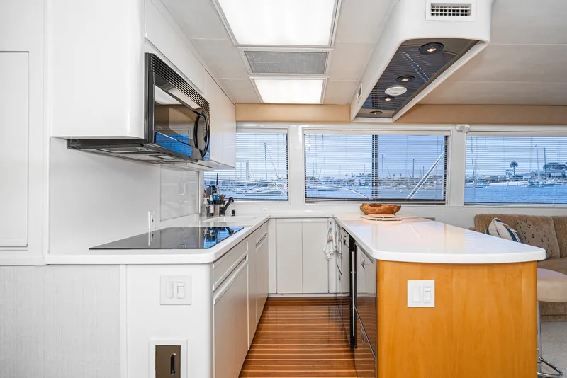 Slide: The Image of Modern kitchen interior of 1990 Hatteras 58 Sportfish yacht with sleek design and ocean view. - 26