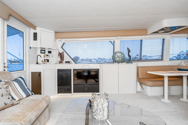 Slide: The Image of Luxurious interior of a 1990 Hatteras 58 Sportfish yacht with modern furnishings and large windows. - 27