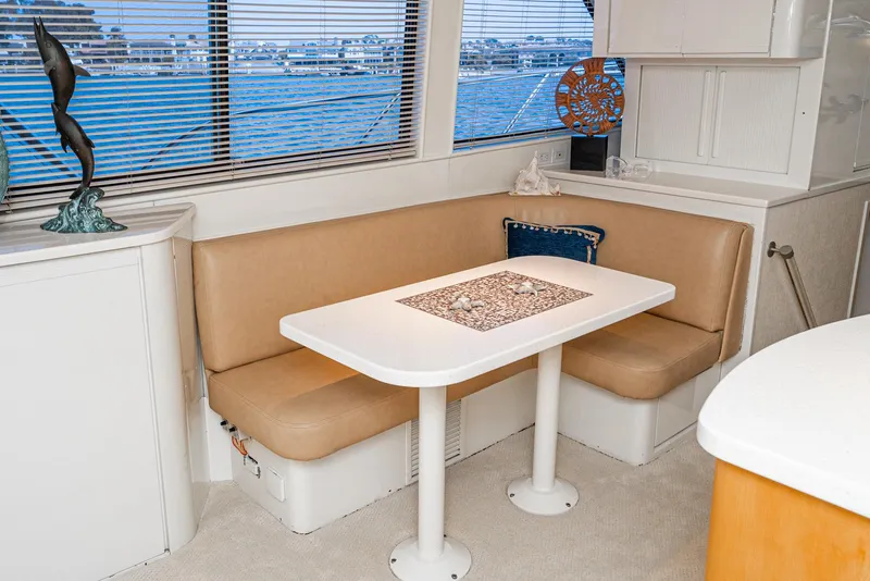 Slide: The Image of Interior of 1990 Hatteras 58 Sportfish with beige seating and white table. - 30