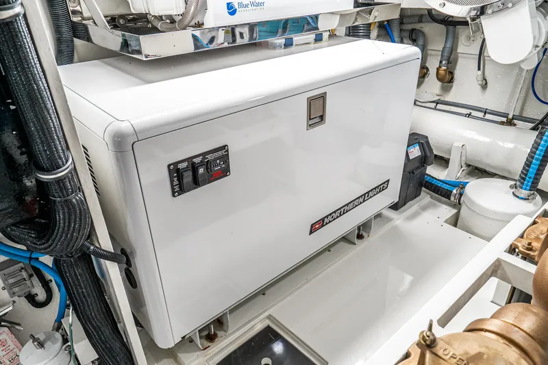 Slide: The Image of Engine room of 1990 Hatteras 58 Sportfish with generator and equipment. - 38