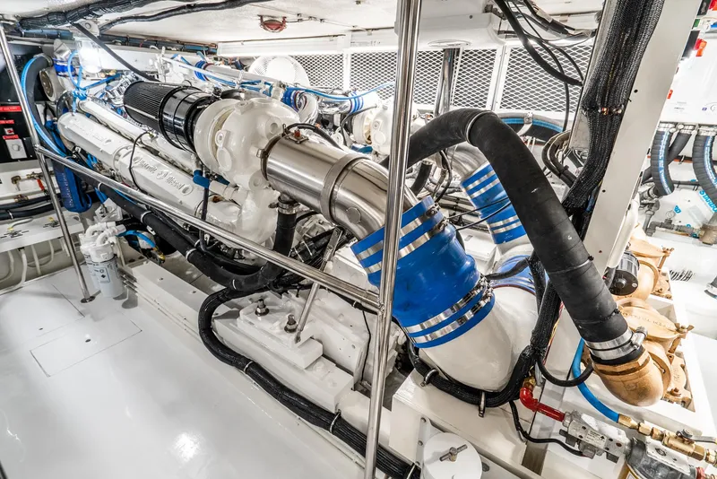 Slide: The Image of Engine room of 1990 Hatteras 58 Sportfish, showcasing powerful marine engine components. - 42