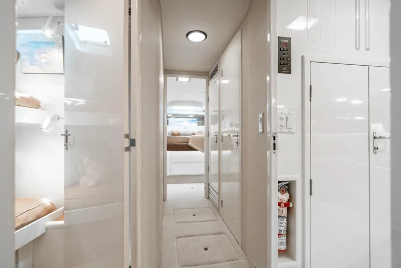 Slide: The Image of Interior hallway of a 1990 Hatteras 58 Sportfish yacht, featuring modern design and storage. - 45