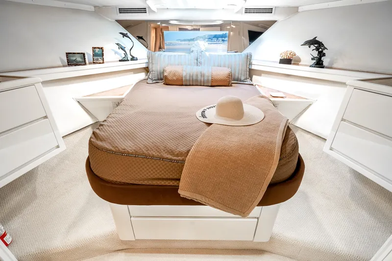 Slide: The Image of Luxurious cabin interior of 1990 Hatteras 58 Sportfish yacht with elegant bedding and decor. - 49