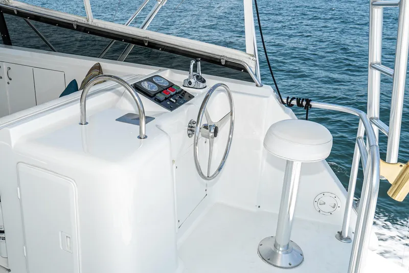 Slide: The Image of Helm of 1990 Hatteras 58 Sportfish yacht with steering wheel and controls. - 9