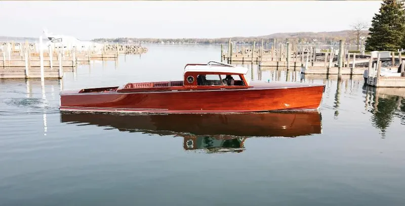 Slide: The Image of Elegant 2015 Van Dam 35 boat on calm water near docks. - 0