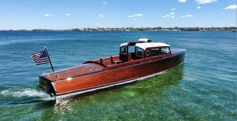 Slide: The Image of Elegant 2015 Van Dam 35 boat cruising on clear blue water under a sunny sky. - 1