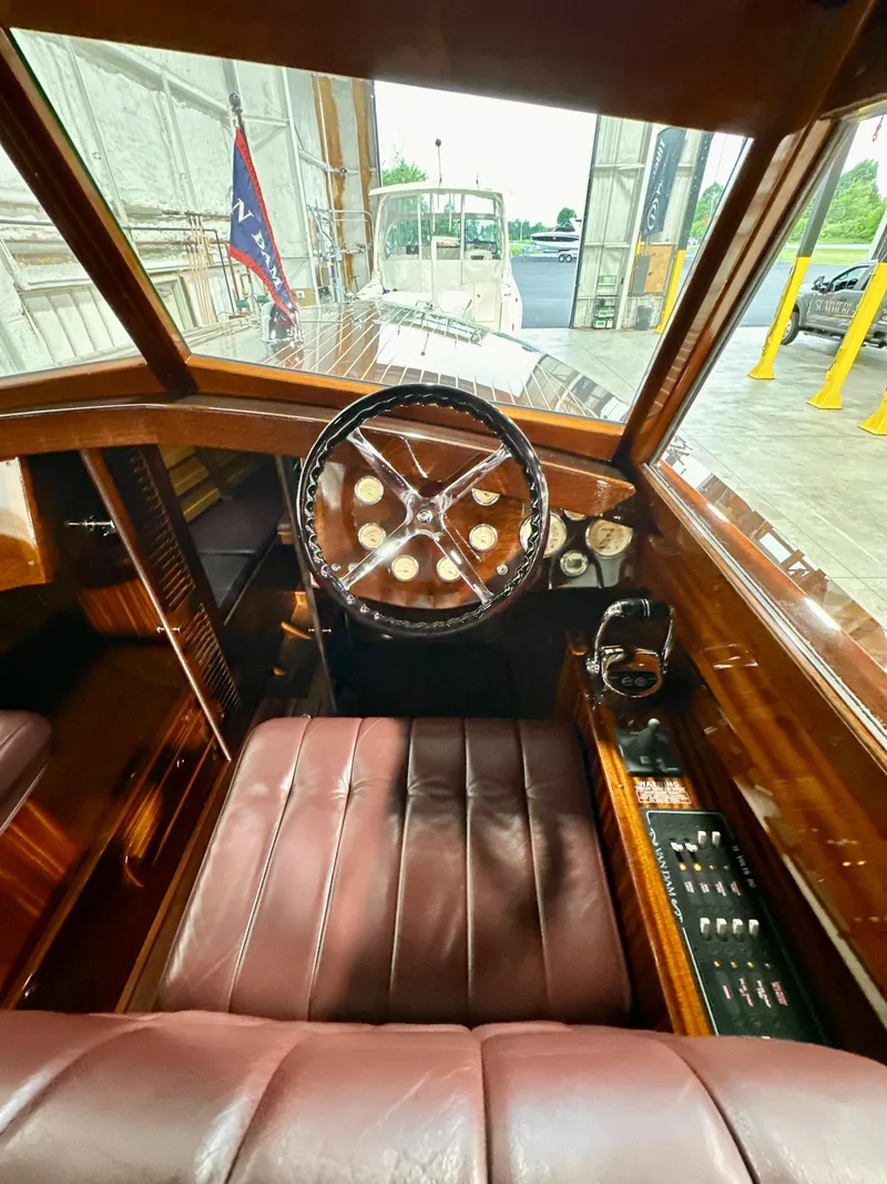 Slide: The Image of Interior of a 2015 Van Dam 35 boat with wooden dashboard and leather seating. - 15