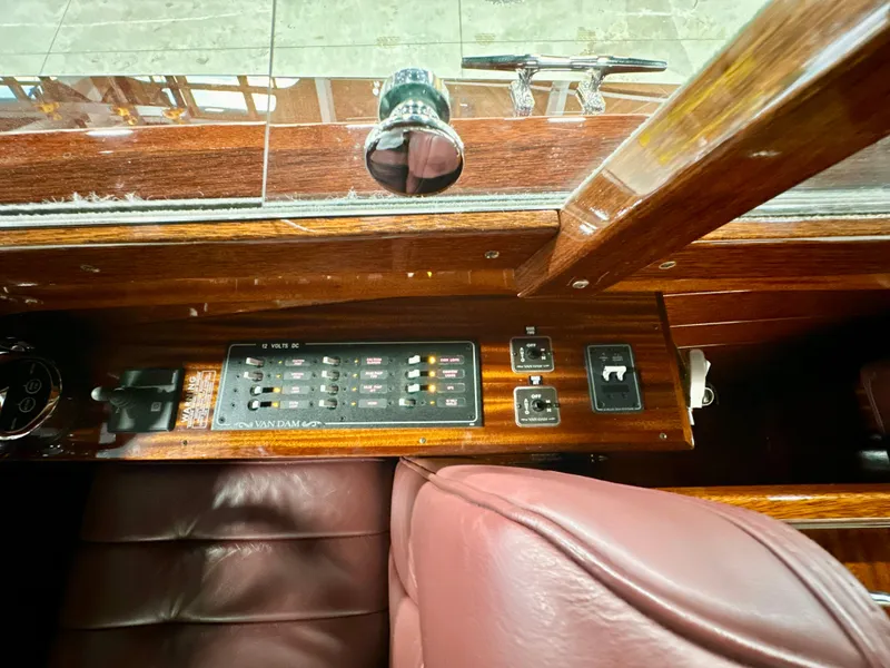 Slide: The Image of Control panel of a 2015 Van Dam 35 boat with leather seating and wooden finish. - 17