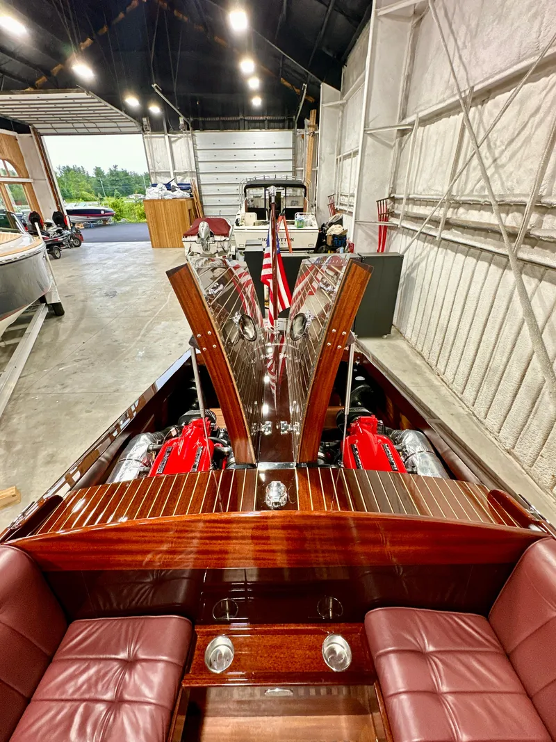Slide: The Image of Luxurious 2015 Van Dam 35 boat with polished wood interior and red leather seats in a spacious garage. - 21