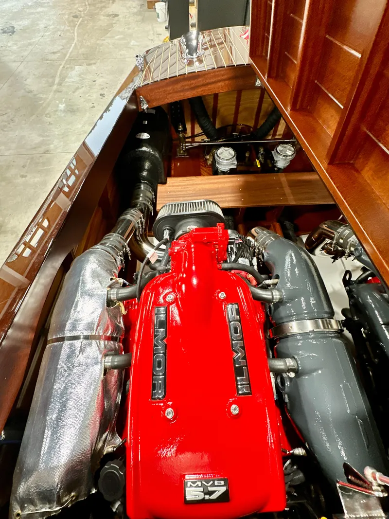 Slide: The Image of Engine compartment of a 2015 Van Dam 35 boat, featuring a powerful red engine. - 23