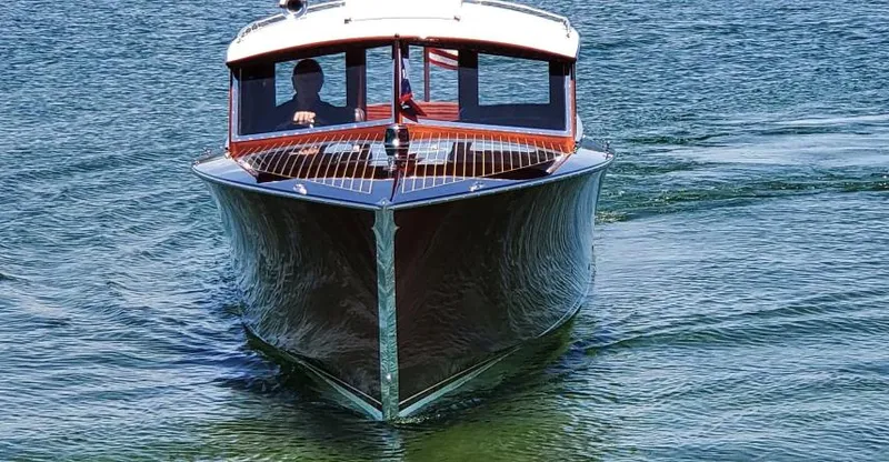 Slide: The Image of Front view of a 2015 Van Dam 35 boat on calm water. - 4