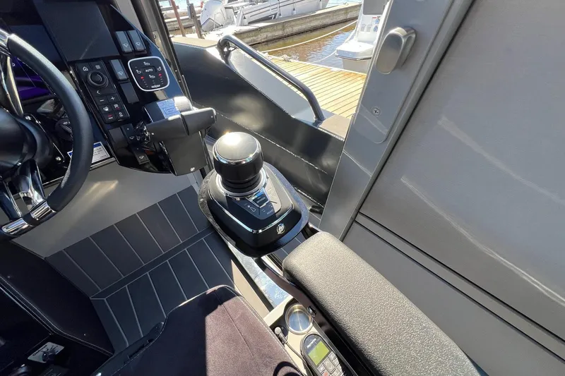 Slide: The Image of Interior of 2024 G-Force 10 boat, featuring modern controls and sleek design. - 14