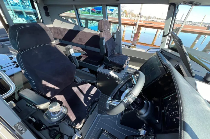 Slide: The Image of 2024 G-Force 10 boat interior with modern steering and seating, dockside view. - 17