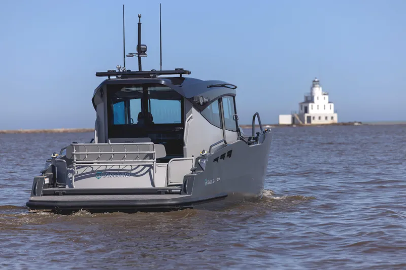 Slide: The Image of 2024 G-Force 10 boat on water with distant lighthouse in background. - 3