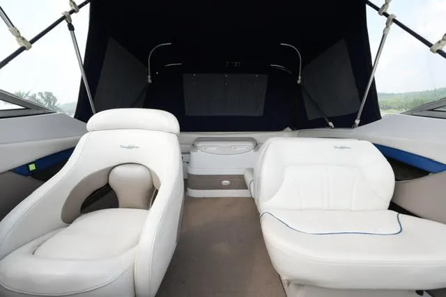Slide: The Image of 2002 Four Winns 225 Sundowner boat interior with white seating and canopy. - 13