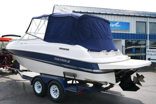 Slide: The Image of 2002 Four Winns 225 Sundowner boat on trailer with blue canopy. - 6