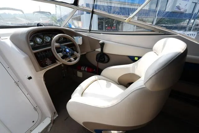 Slide: The Image of 2002 Four Winns 225 Sundowner boat interior with steering wheel and dashboard. - 8