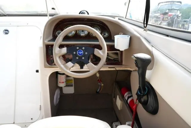 Slide: The Image of 2002 Four Winns 225 Sundowner boat dashboard with steering wheel and controls. - 9