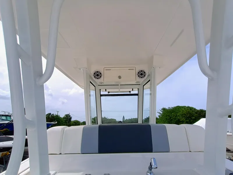 Slide: The Image of 2025 Robalo R270 Center Console boat interior with seating and overhead speakers. - 13