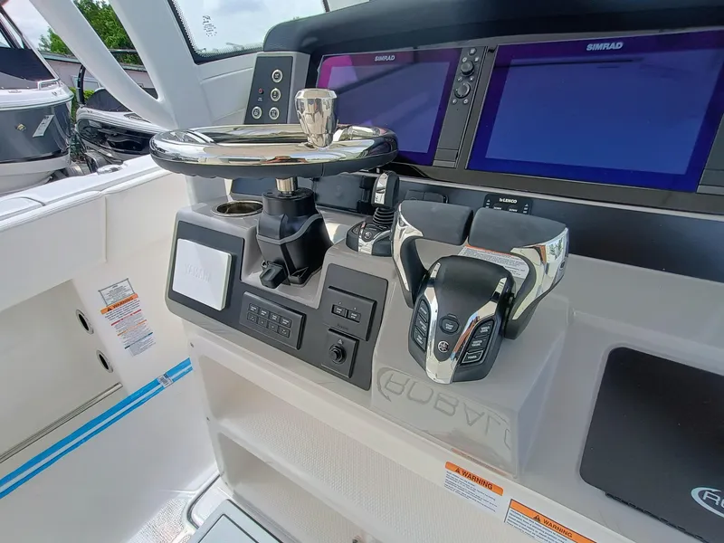 Slide: The Image of 2025 Robalo R270 Center Console helm with advanced controls and dual navigation screens. - 16