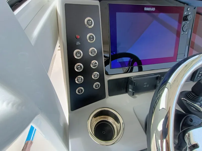 Slide: The Image of 2025 Robalo R270 Center Console dashboard with Simrad display and control panel. - 18