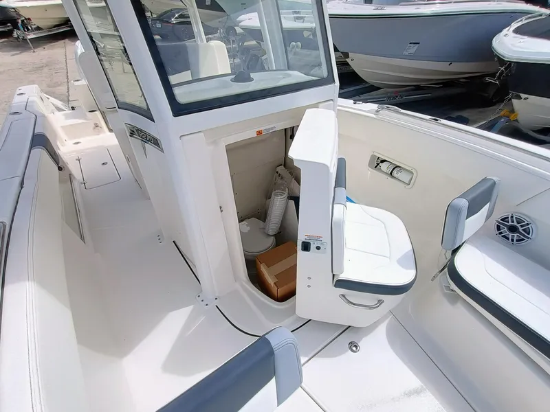 Slide: The Image of 2025 Robalo R270 Center Console boat interior with open storage compartment and seating. - 25