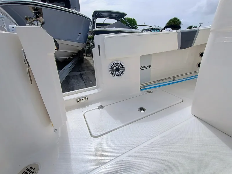 Slide: The Image of 2025 Robalo R270 Center Console boat interior with open deck and storage compartment. - 31