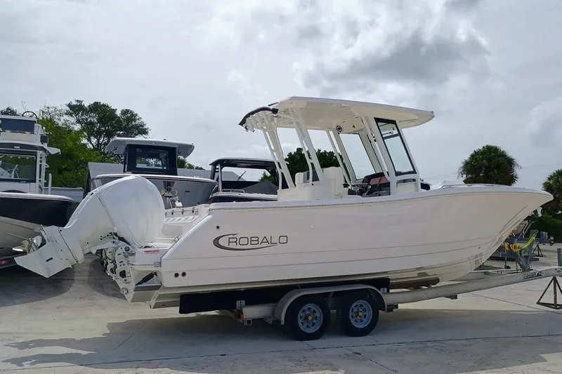 Slide: The Image of 2025 Robalo R270 Center Console boat on trailer, parked outdoors. - 39