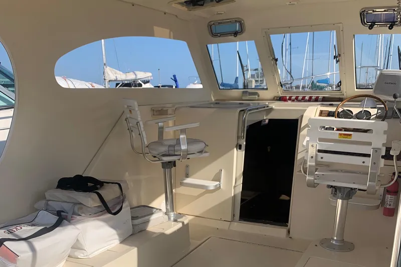 Slide: The Image of 2004 Mainship Pilot 30-II Sedan interior with helm, seating, and nautical equipment. - 10