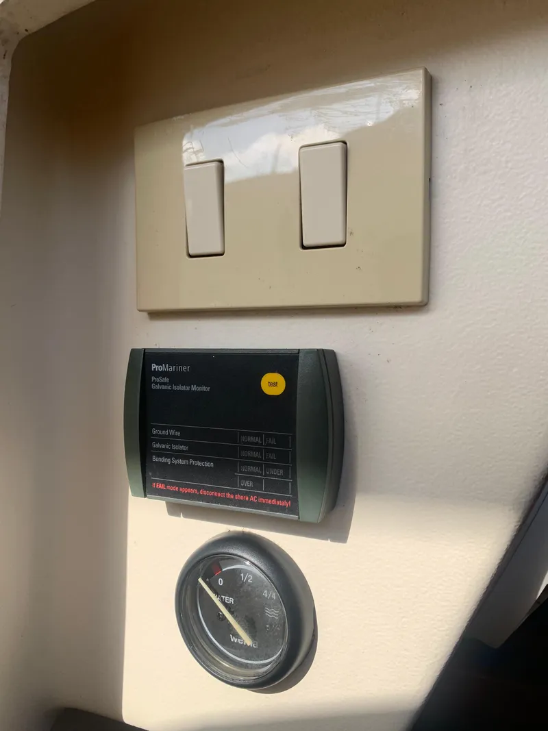 Slide: The Image of Control panel and switches inside a 2004 Mainship Pilot 30-II Sedan boat. - 14