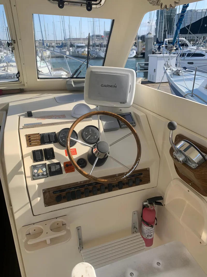 Slide: The Image of 2004 Mainship Pilot 30-II Sedan helm with Garmin GPS, docked in marina. - 6