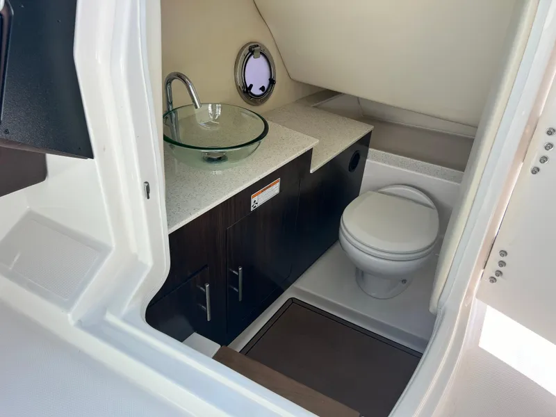 Slide: The Image of 2016 Regal 3200 Bowrider boat bathroom with modern sink and toilet. - 7