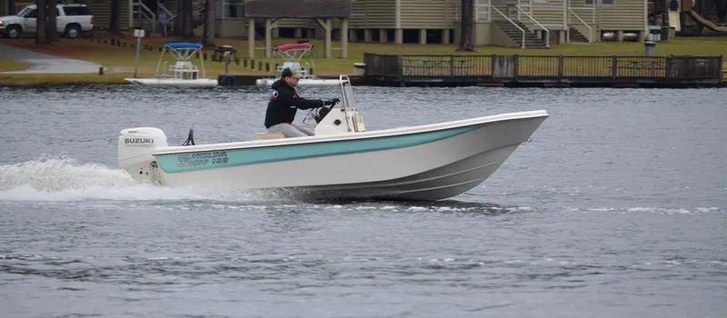 The Image of 2025 Carolina Skiff 162 JLS boat cruising on a calm lake. - 1